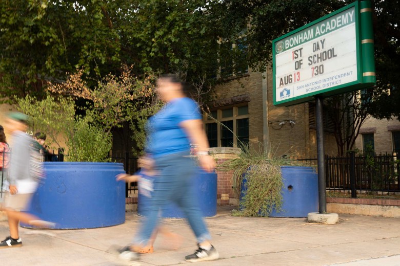 Bonham Academy families arrive to campus on the first day of the new school year. Children from districts across Bexar County are getting back to school after summer break.