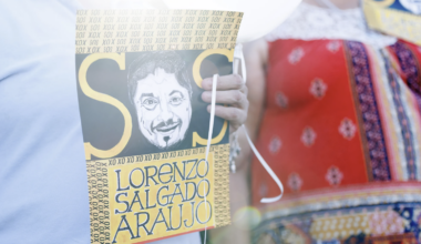 Vigil attendees hold up signs at a memorial for Lorenzo Salgado Araujo on the one month anniversary of his death, in Houston on Aug. 7, 2026.