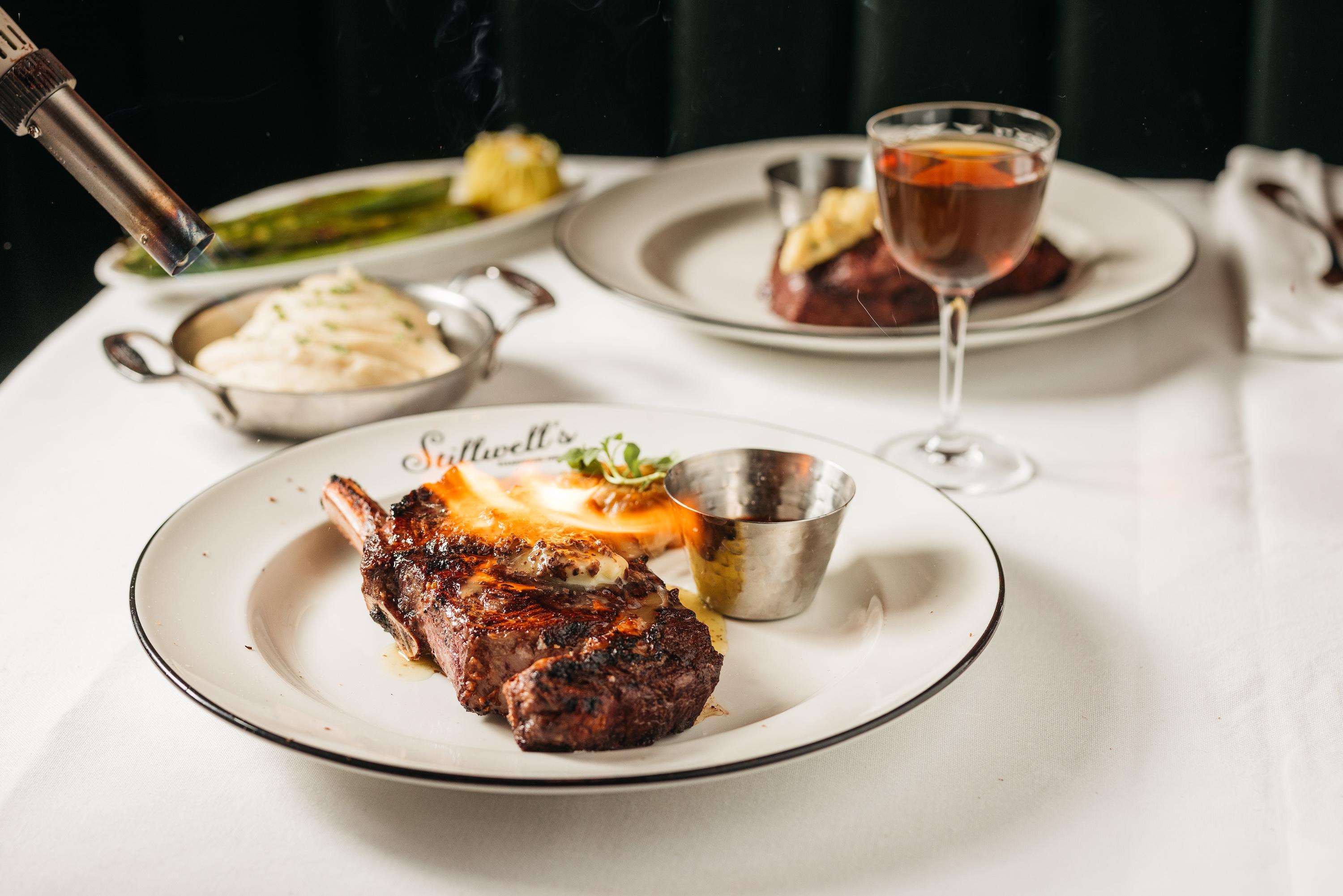 a steak being torhced on a plate at Stillwell's