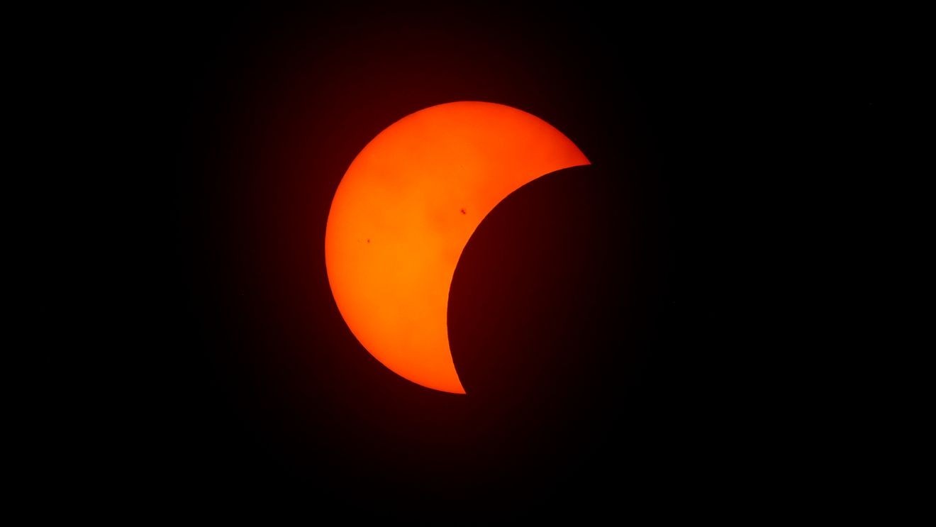 FORT WORTH, TEXAS - APRIL 8: The moon begins to eclipse the sun on April 8, 2024 in Fort Worth, Texas. Millions of people have flocked to areas across North America that are in the "path of totality" in order to experience a total solar eclipse. During the event, the moon will pass in between the sun and the Earth, appearing to block the sun. (Photo by Ron Jenkins/Getty Images)
