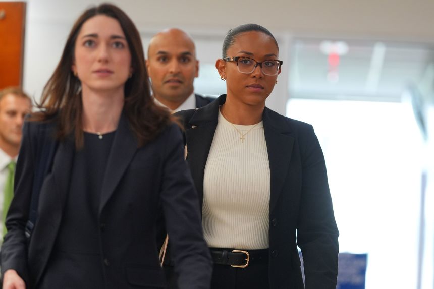 McKenna West, right, walks in a hallway at family court after a hearing Tuesday in Dallas.