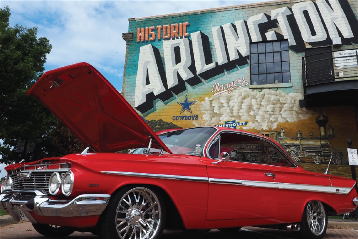 Classic red car in front of Downtown Arlington mural at the Downtown Arlington Car Show