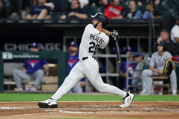 White Sox center fielder Tristan Peters (29) hits a two-run homer during the second inning against the Rangers at Rate Field Aug. 24, 2026 in Chicago. (Armando L. Sanchez/Chicago Tribune)
