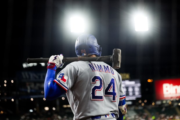 Rangers right fielder Brandon Nimmo (24) holds a sledgehammer during the fifth inning against the White Sox at Rate Field Aug. 24, 2026 in Chicago. (Armando L. Sanchez/Chicago Tribune)