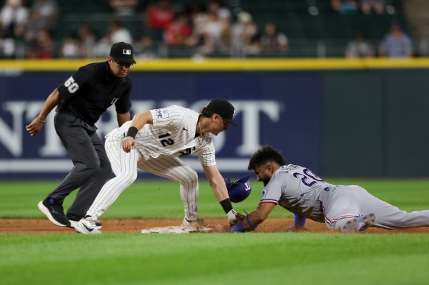 White Sox shortstop Colson Montgomery (12) tags out Rangers shortstop Ezequiel Duran (20) while he tries to steal second during the sixth inning at Rate Field Aug. 24, 2026 in Chicago. (Armando L. Sanchez/Chicago Tribune)