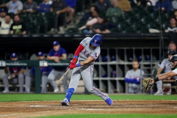 Rangers second baseman Nicky Lopez (33) hits a single during the ninth inning against the White Sox at Rate Field Aug. 24, 2026 in Chicago. (Armando L. Sanchez/Chicago Tribune)