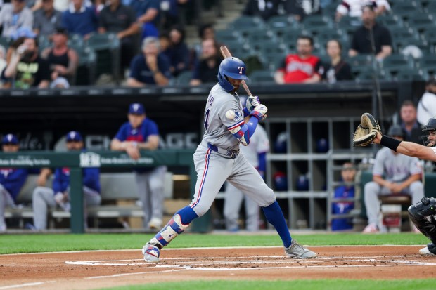 Rangers right fielder Brandon Nimmo (24) gets hit by a pitch from White Sox pitcher José Urquidy (70) during the first inning at Rate Field Aug. 24, 2026 in Chicago. (Armando L. Sanchez/Chicago Tribune)