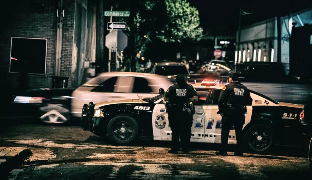 Dallas police officers in Deep Ellum at night