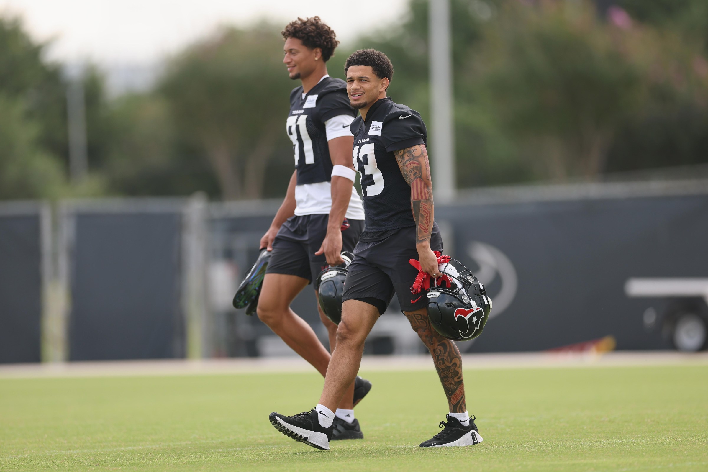 HOUSTON, TEXAS - JUNE 02: Jaylin Noel #13 of the Houston Texans and Jayden Higgins #81 arrive during OTA Offseason Workouts at Houston Methodist Training Center on June 02, 2026 in Houston, Texas. (Photo by Tim Warner/Getty Images)
