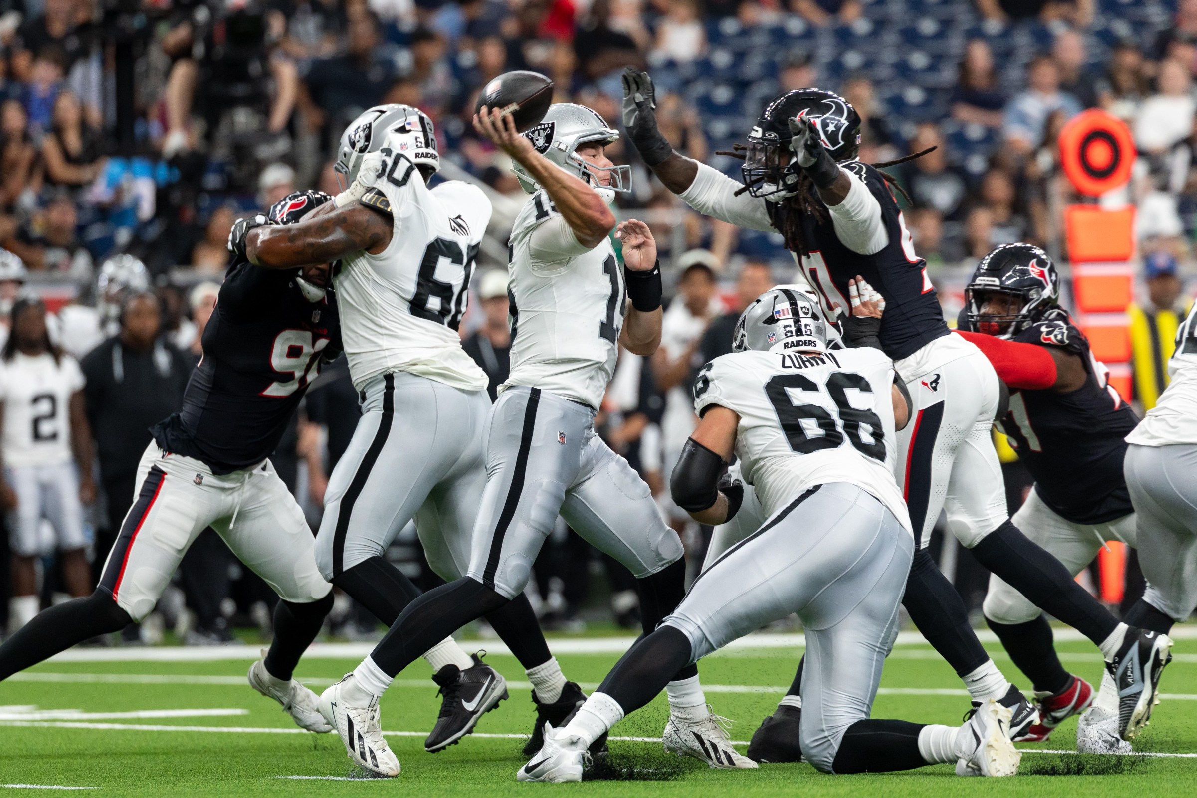 HOUSTON, TX - AUGUST 20: Quarterback Fernando Mendoza #15 of the Las Vegas Raiders throws the ball as he is pressured by defensive end Jadeveon Clowney #90 of the Houston Texans during the NFL preseason game between the Houston Texans and the Las Vegas Raiders on August 20, 2026, at Reliant Stadium in Houston, TX. (Photo by David Buono/Icon Sportswire via Getty Images)
