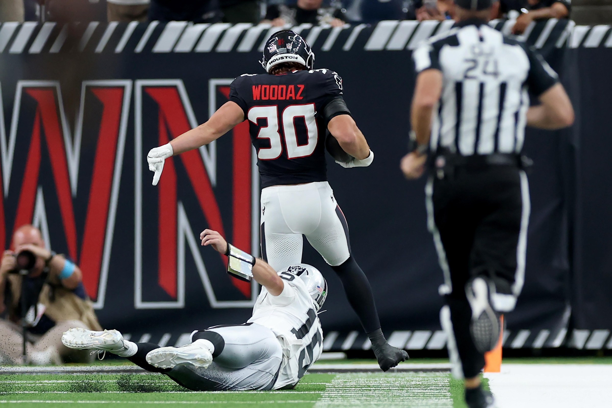 HOUSTON, TEXAS - AUGUST 20: Wade Woodaz #30 of the Houston Texans returns an interception for a touchdown as Fernando Mendoza #15 of the Las Vegas Raiders attempts to make the tackle in the first half during a preseason game at Reliant Stadium on August 20, 2026 in Houston, Texas. (Photo by Tim Warner/Getty Images)