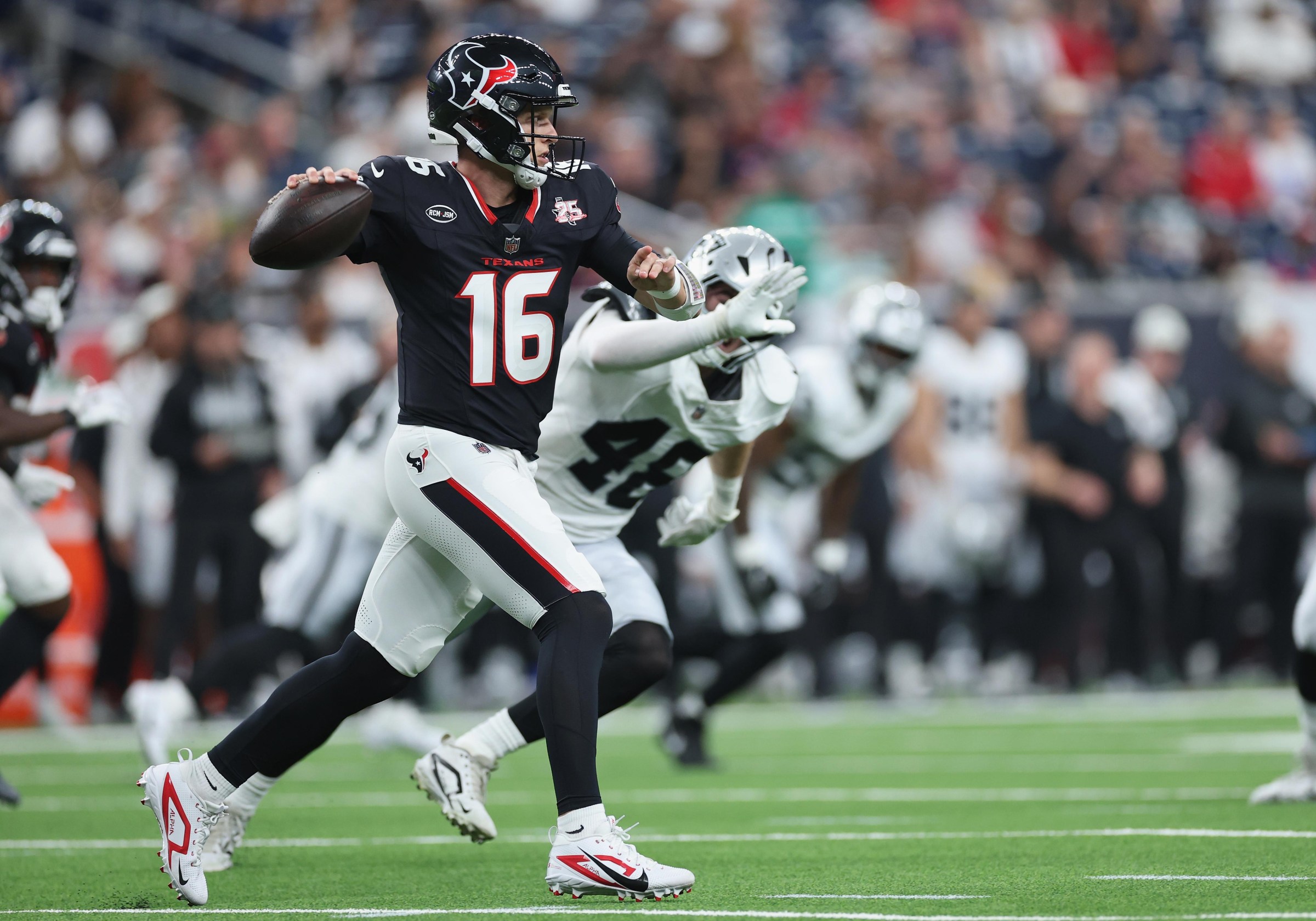 HOUSTON, TEXAS - AUGUST 20: Brett Rypien #16 of the Houston Texans rolls out to pass in the second half against the Las Vegas Raiders during a preseason game at Reliant Stadium on August 20, 2026 in Houston, Texas. (Photo by Tim Warner/Getty Images)