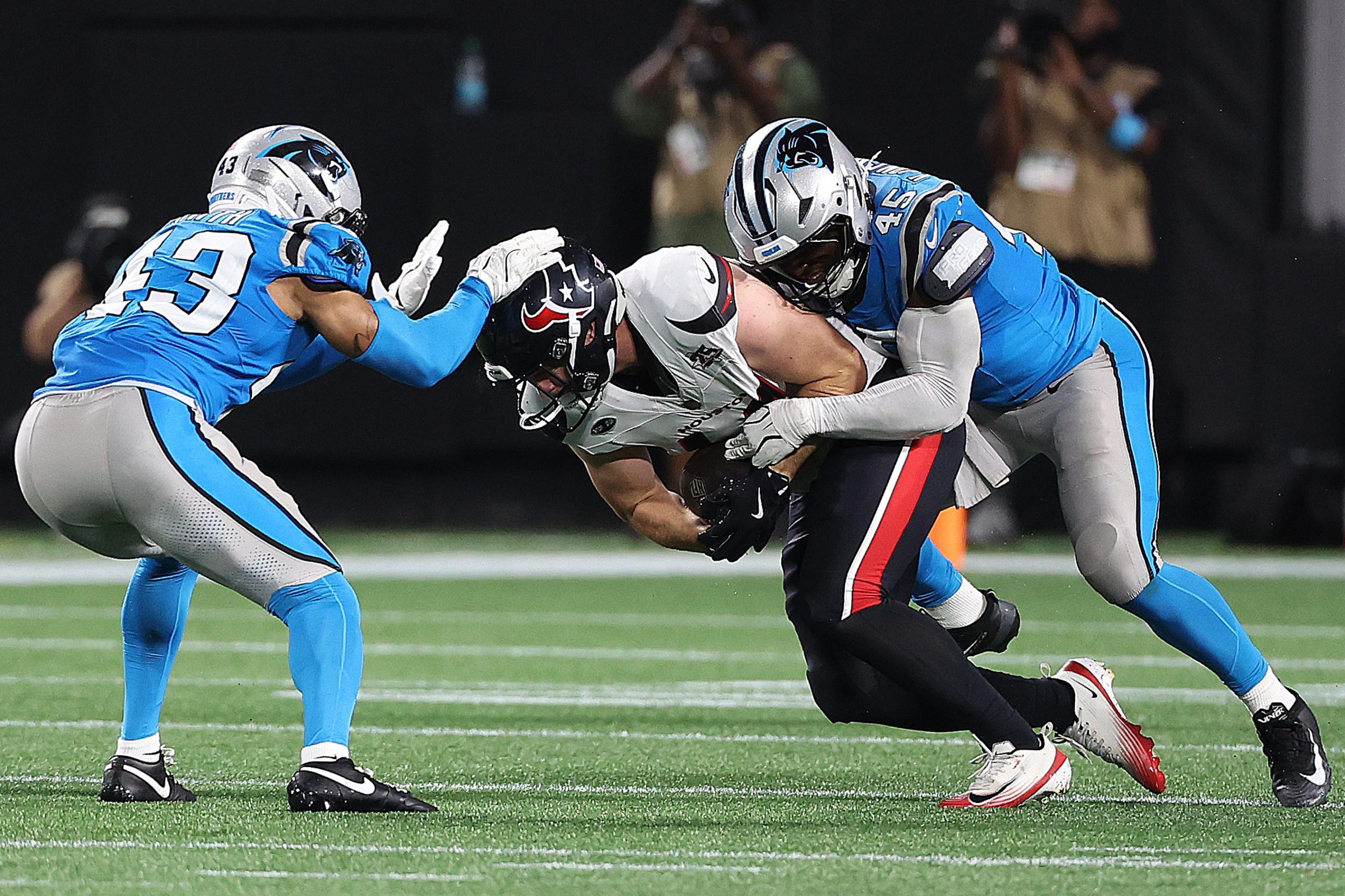 CHARLOTTE, NC - AUGUST 28: Houston Texans tight end Louis Hansen (47) is tackled by Carolina Panthers corner back DeVonta Smith (43) and Carolina Panthers linebacker Maema Njongmeta (45) during a preseason NFL football game between the Houston Texans and the Carolina Panthers on August 28, 2026, at Bank of America Stadium in Charlotte, N.C.(Photo by John Byrum/Icon Sportswire via Getty Images)