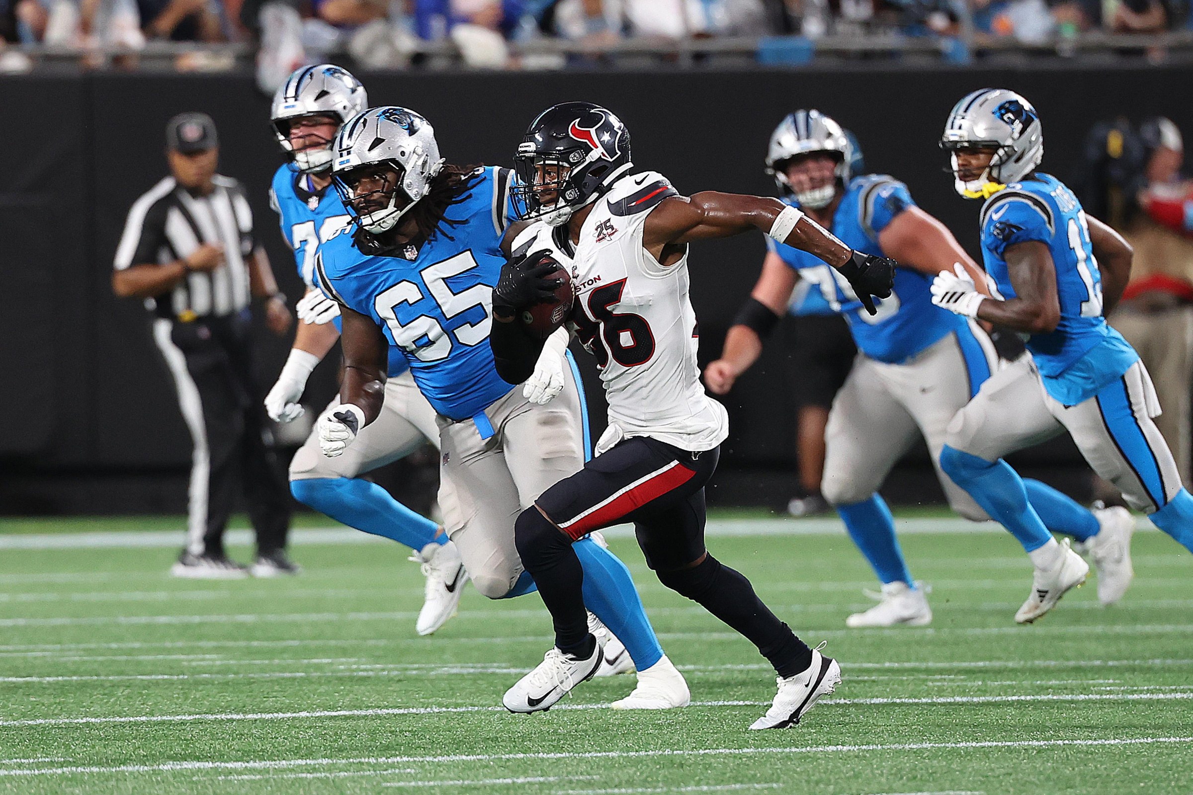 CHARLOTTE, NC - AUGUST 28: Houston Texans safety George Odum (36) runs with the ball after making an interception during a preseason NFL football game between the Houston Texans and the Carolina Panthers on August 28, 2026, at Bank of America Stadium in Charlotte, N.C.(Photo by John Byrum/Icon Sportswire via Getty Images)