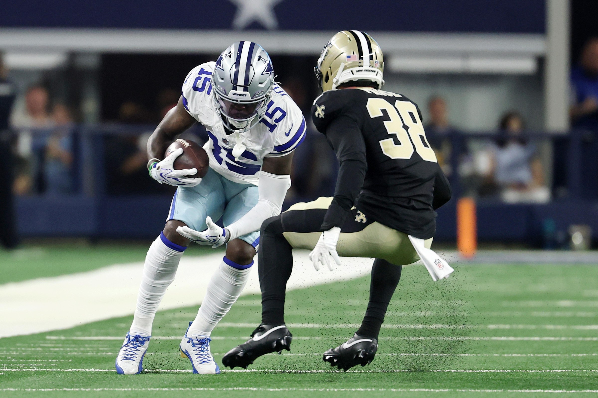 ARLINGTON, TEXAS - AUGUST 28: Tyler Johnson #15 of the Dallas Cowboys is pursued by Jayden Price #38 of the New Orleans Saints during the second quarter of an NFL Preseason 2026 game at AT&T Stadium on August 28, 2026 in Arlington, Texas. (Photo by Stacy Revere/Getty Images)