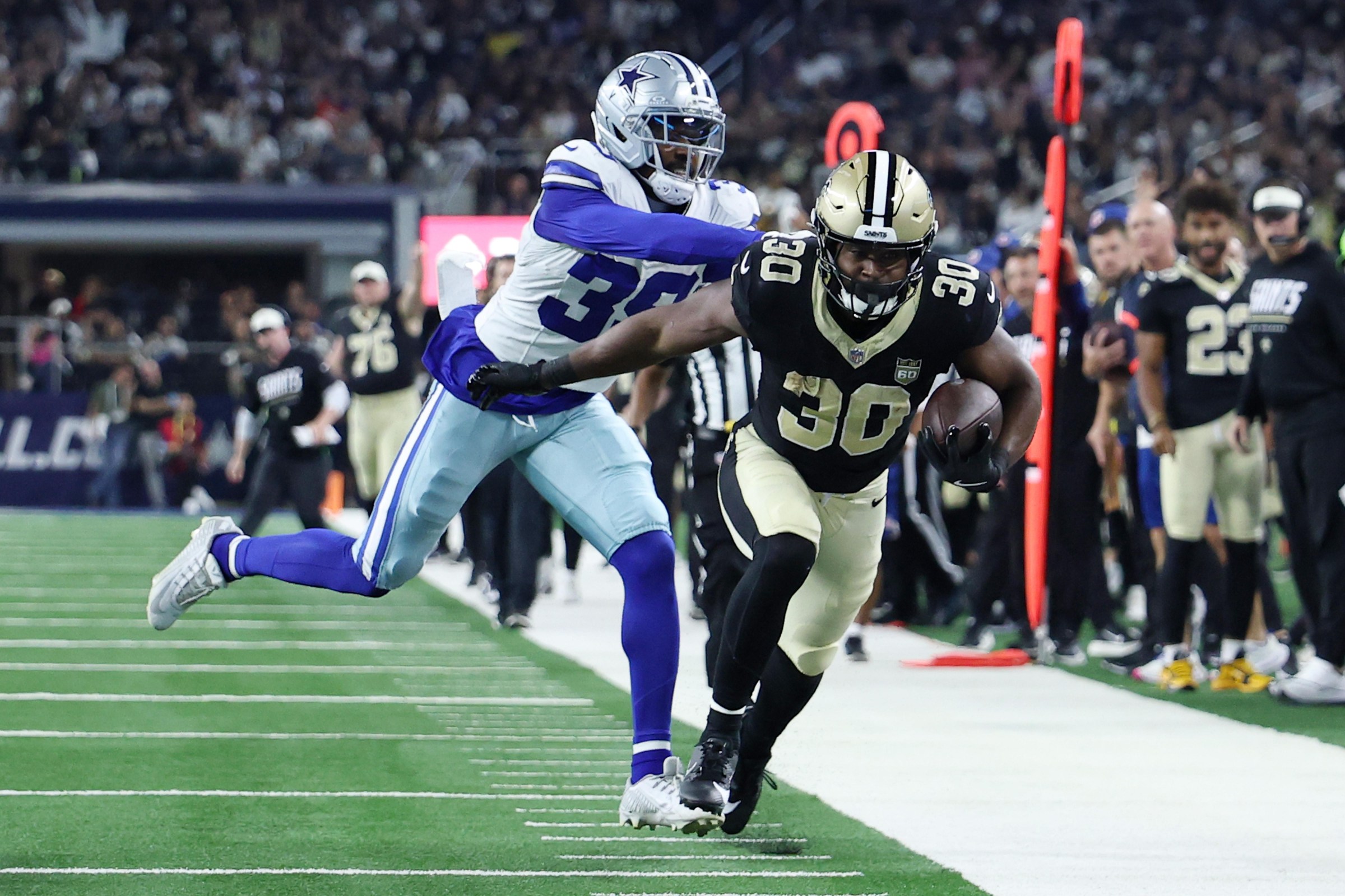 ARLINGTON, TEXAS - AUGUST 28: Audric Estime #30 of the New Orleans Saints is pushed out of bounds by Ameer Speed #39 of the Dallas Cowboys during the second quarter of an NFL Preseason 2026 gameat AT&T Stadium on August 28, 2026 in Arlington, Texas. (Photo by Stacy Revere/Getty Images)