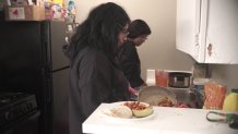 Dulce and Maria Zepeda make dinner in their apartment.