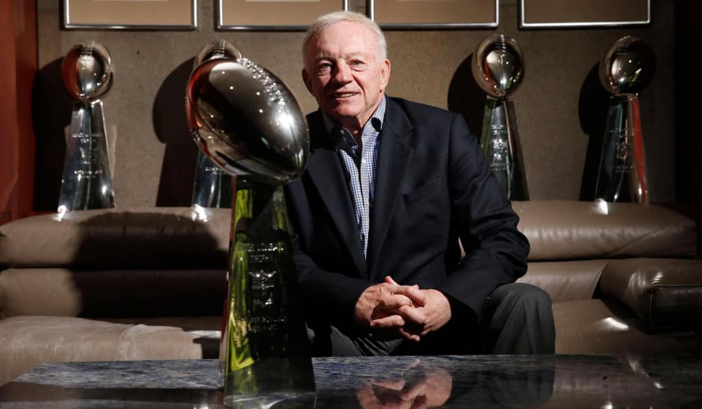 Could Dallas Pull Off A Deion Sanders-Level Move? Jerry Jones sits in front of the Dallas Cowboys’ five Lombardi Trophies at team headquarters.