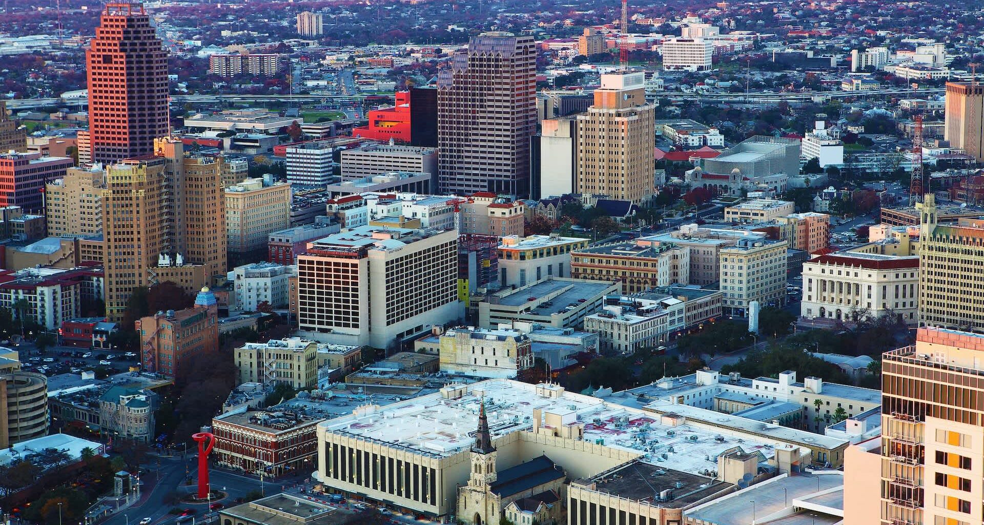 Aerial view of a cityscape featuring a mix of modern and historic buildings.
