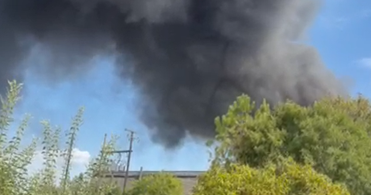 Firefighters battle blaze after at least 30 cars catch fire in Grand Prairie, officials say