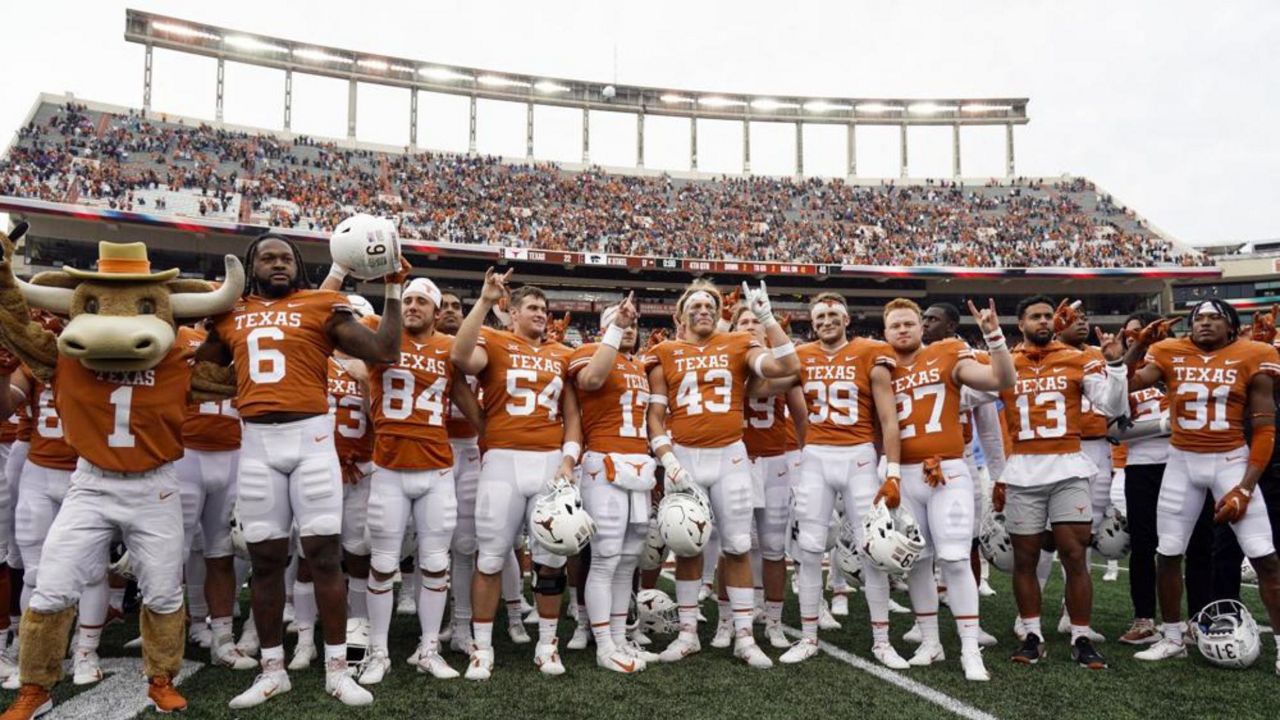 Texas players sing "The Eyes Of Texas" after defeating Kansas State 22-17 in an NCAA college football game in Austin, Texas, Friday, Nov. 26, 2021. (AP Photo/Chuck Burton)