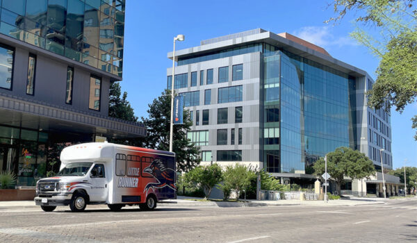 The Little Runner shuttle drives by the San Pedro I and II buildings on Dolorosa St.