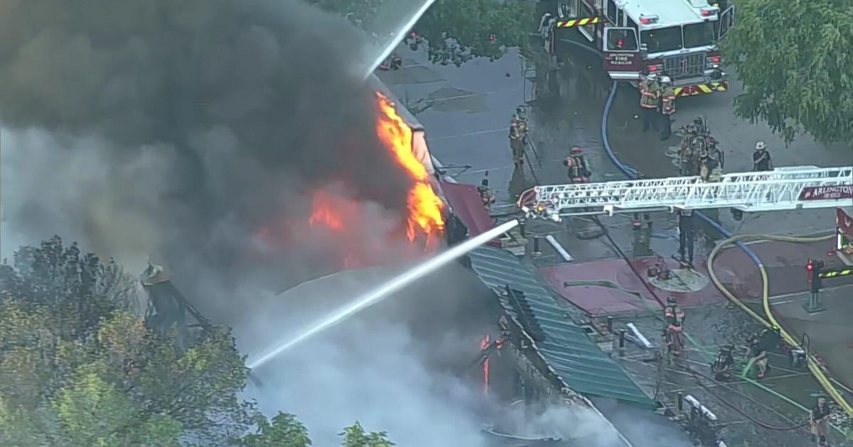 Arlington firefighters work to contain structure fire in 2400 block of West Abram Street
