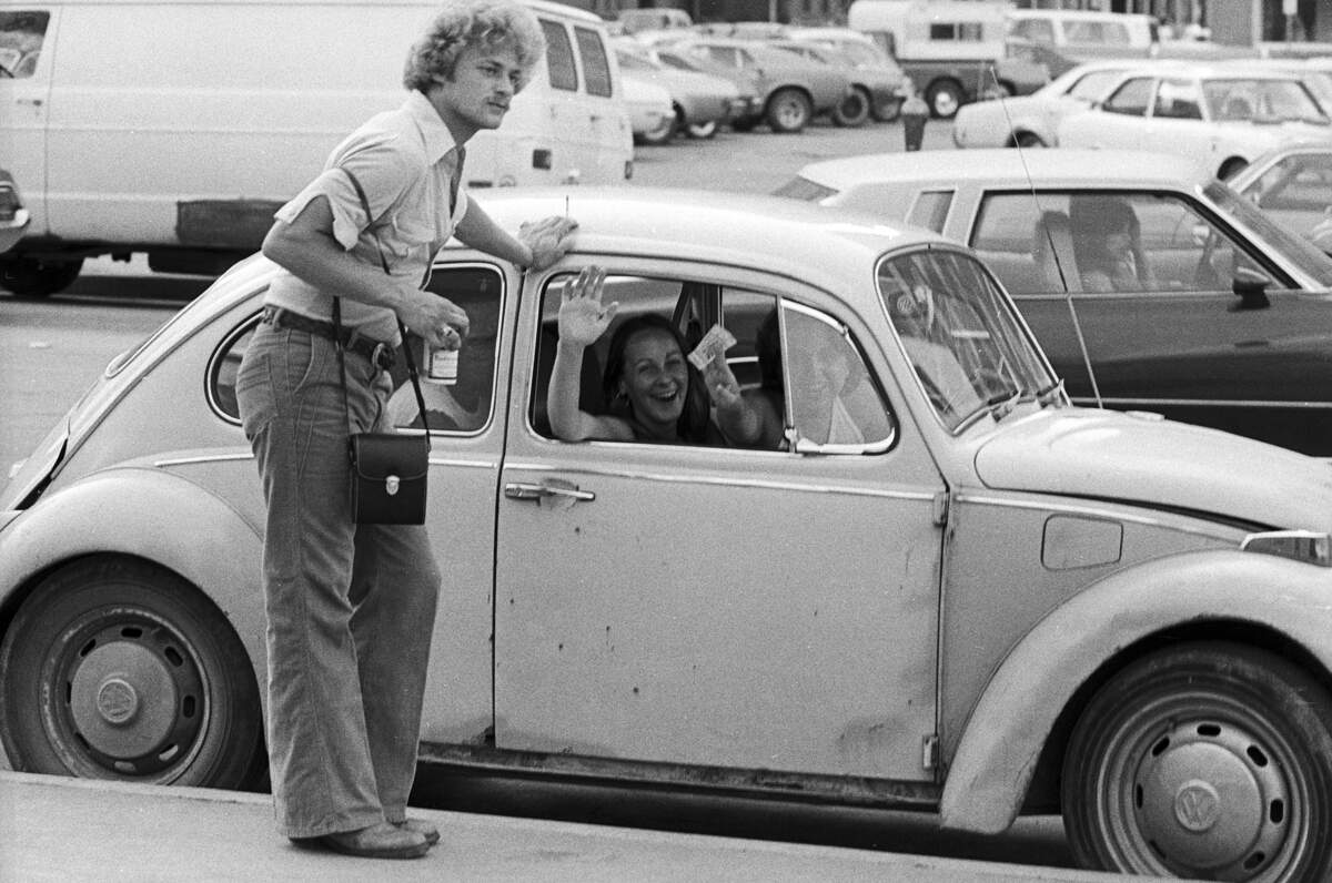Led Zeppelin fans are pictured in a parking lot ahead of the Led Zeppelin concert at the Tarrant County Convention Center on May 22, 1977.
