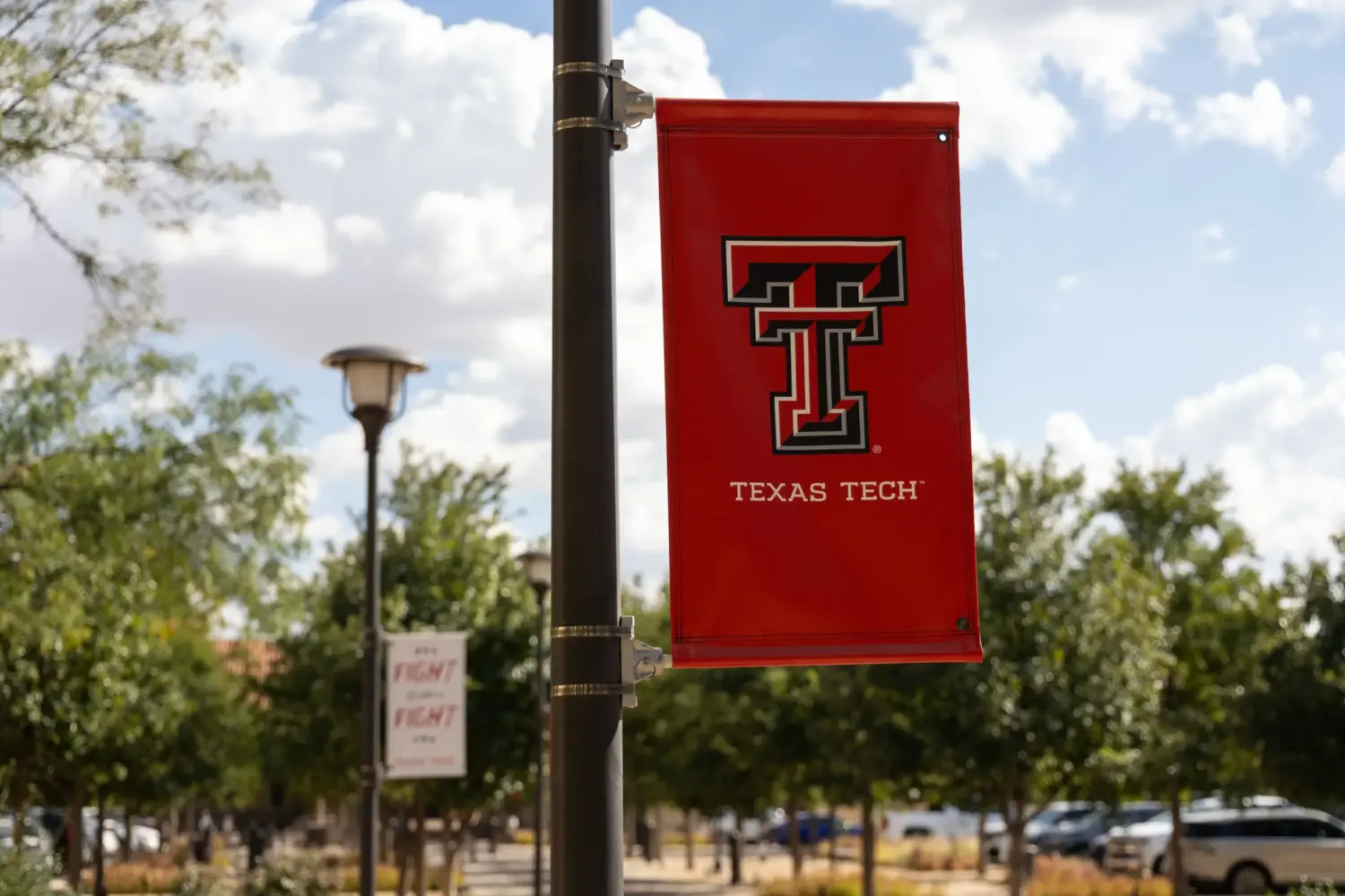 A Texas Tech University banner hangs from a light pole on the university’s campus in Lubbock, Texas.