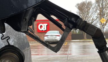 A QuikTrip sign is seen behind a gas pump at a station on Cockrell Hill Road in Duncanville, Texas. The Tulsa-based convenience store chain says its $10 million gift is intended to secure naming rights to the basic training building at Dallas’ new police academy.