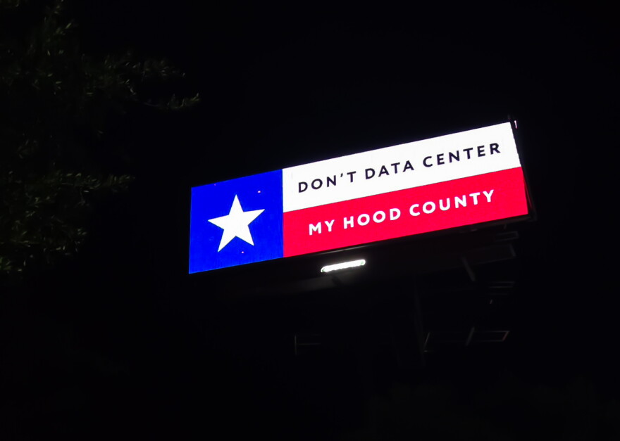 A billboard in Hood County opposes proposed Al-related data centers as residents raise concerns over water use, noise and environmental impacts.