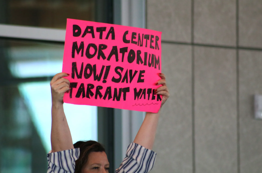A protester holds up a sign demanding a moratorium on new data center development during the July 8, 2026, meeting of the Fort Worth Zoning Commission to consider proposed new regulations on data centers. ()