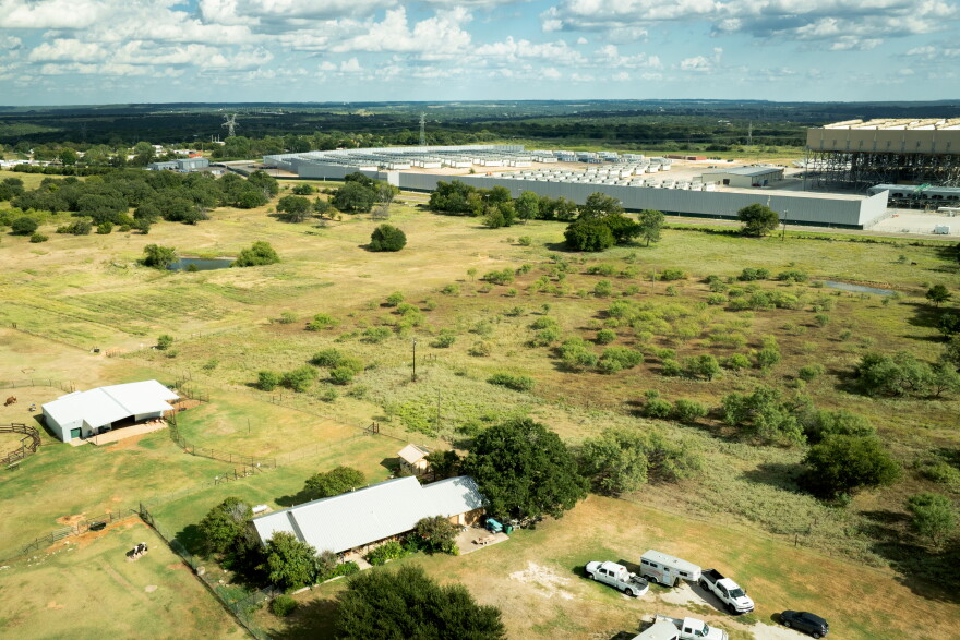 Aerial view of a house in a rural area with the Marathon Digital bitcoin mine in the background in Hood County.
