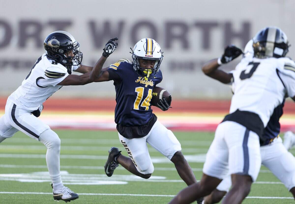 Arlington Heights running back Jaquan Evans (14) runs the ball during the game against Cleburne on Thursday, Sept. 3, 2026 at Farrington Field in Fort Worth.