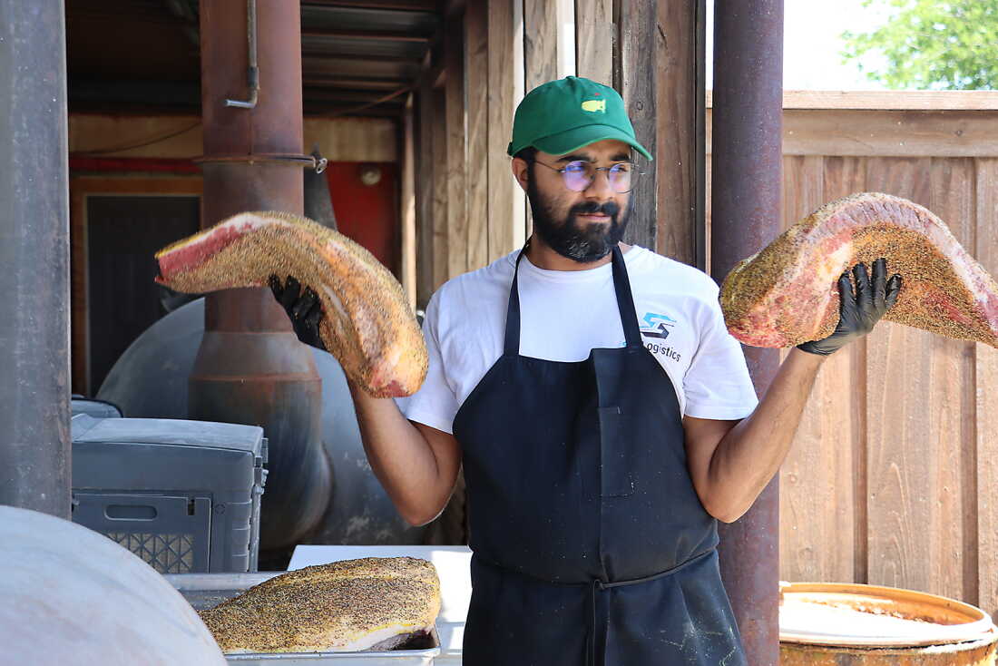 Zain Shafi prepares to put briskets in the smoker at Goldee’s BBQ in Fort Worth, Texas.