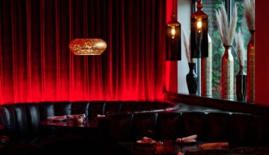 An empty booth with a red curtain behind it.