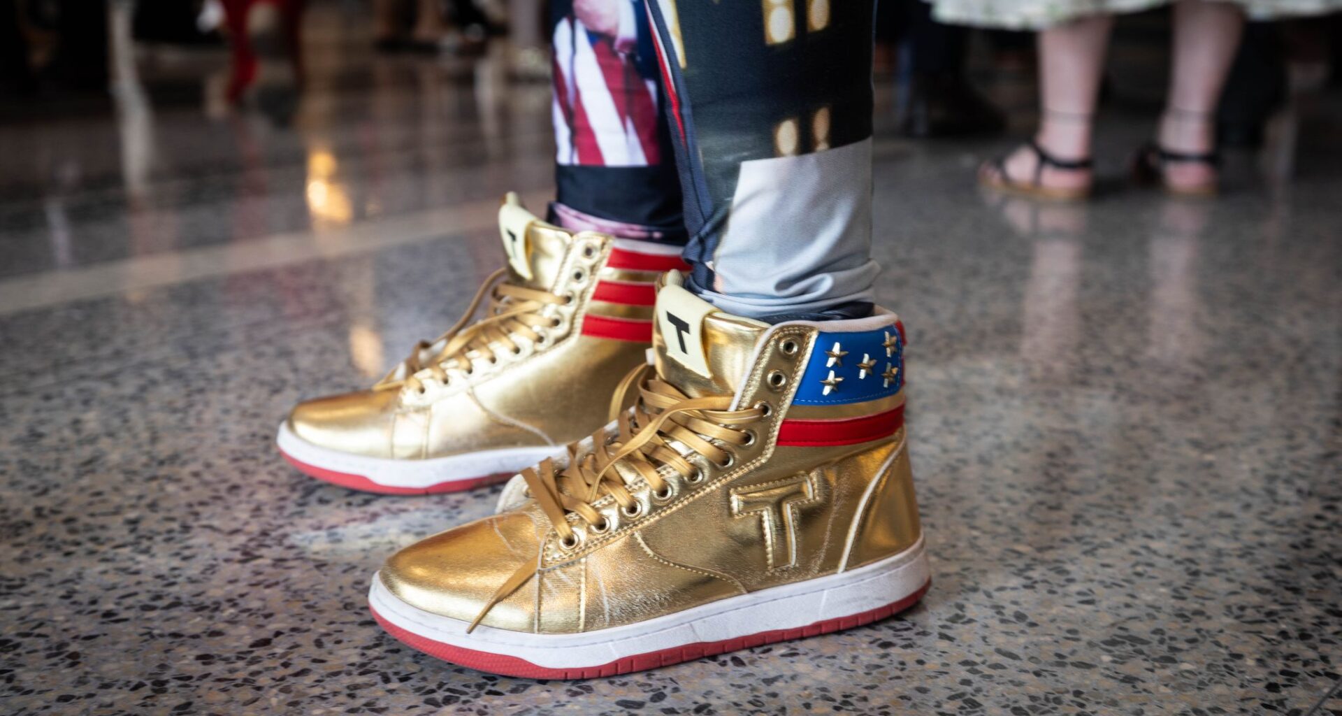 A woman wears gold shoes during the Republican convention at the American Airlines Center in Dallas, Wednesday, Sept. 9, 2026.
