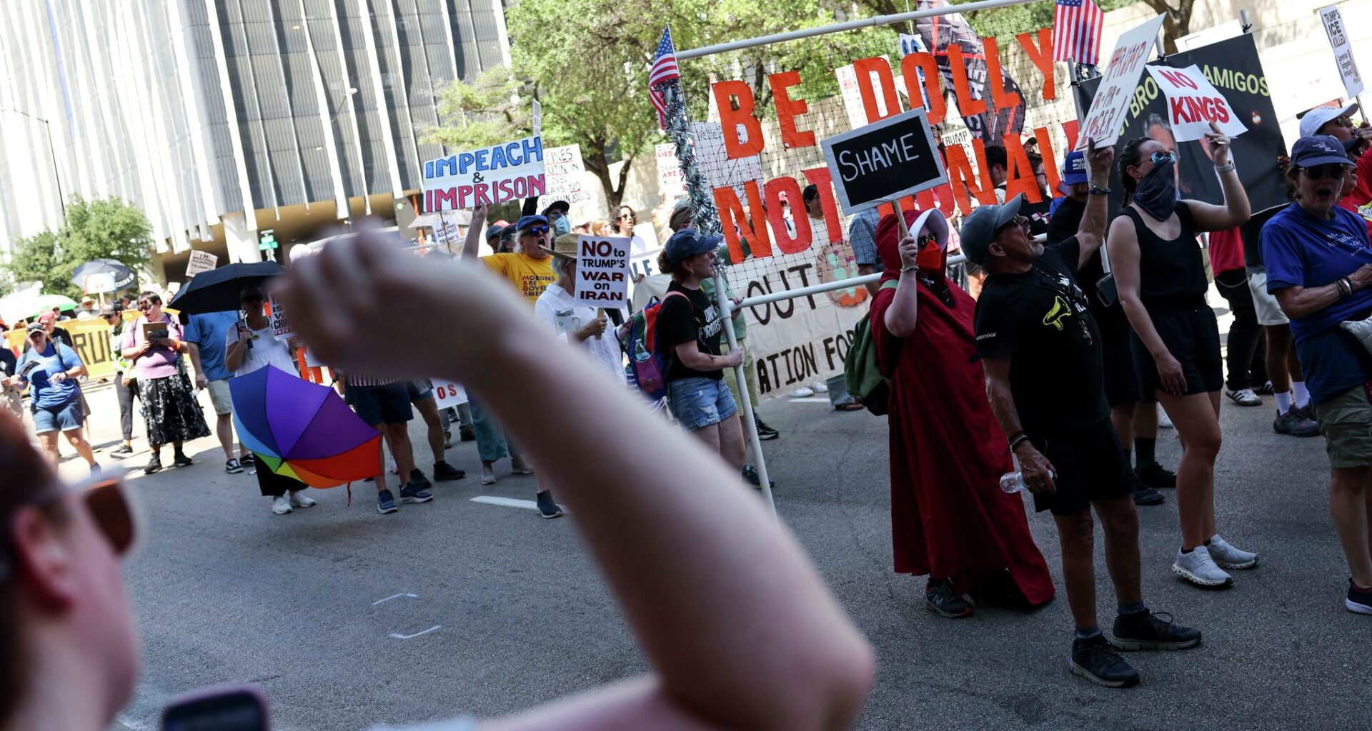 Police officers watch demonstrators marching around Pike Park to protest against President Trump and Republican leaders near the venue of the Republican convention at American Airlines Center, Thursday, Sept. 10, 2026, in Dallas.