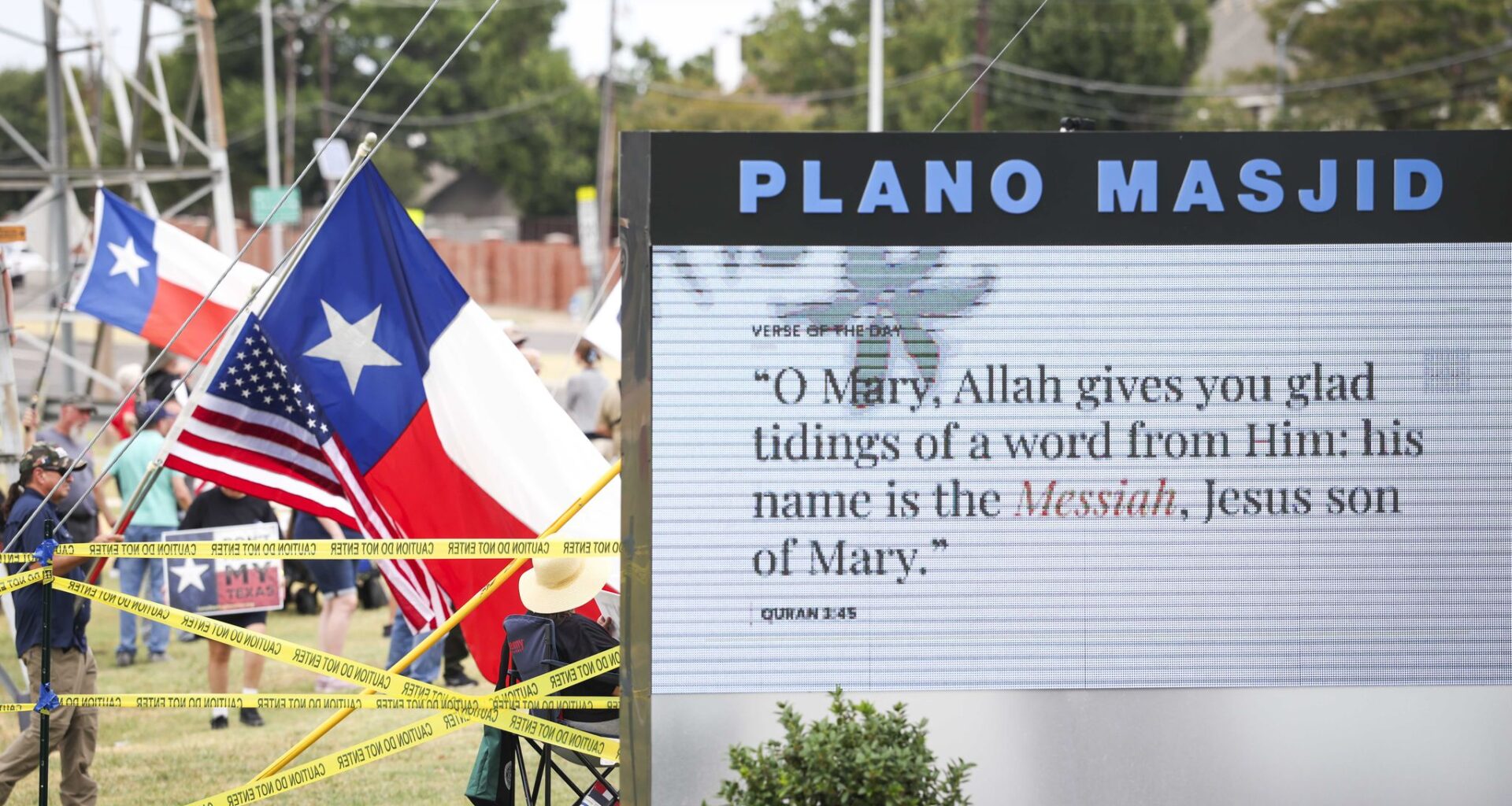 Protesters hold signs opposing Sharia law is seen from the premises of the Islamic Association of Collin County on Friday, Sept. 11, 2026, in Plano.