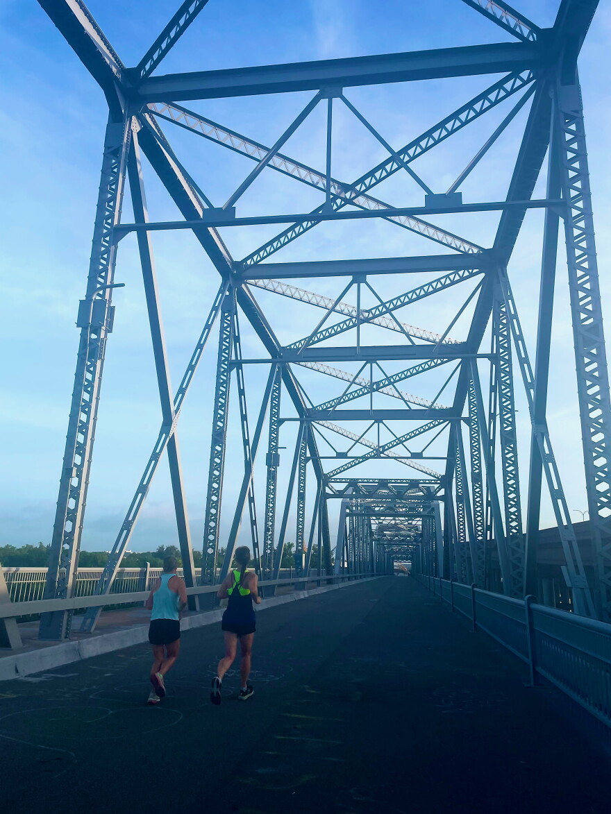 Two runners cross Montopolis Bridge in east Austin.