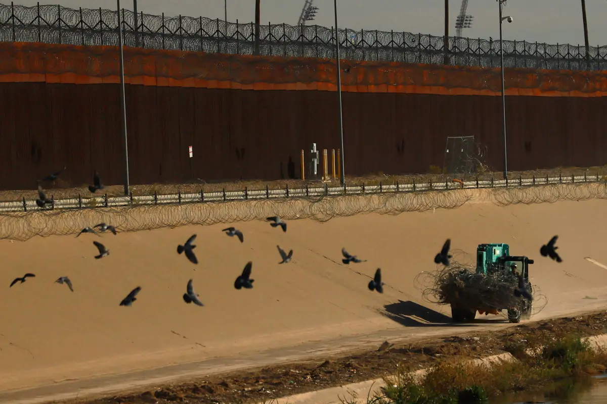 A member of the Texas National Guard operates machinery while replacing razor wire fence near the U.S.-Mexico border wall, as tensions rise over the use of drones by suspected criminal groups, as seen from Ciudad Juarez, Mexico, February 12, 2026.