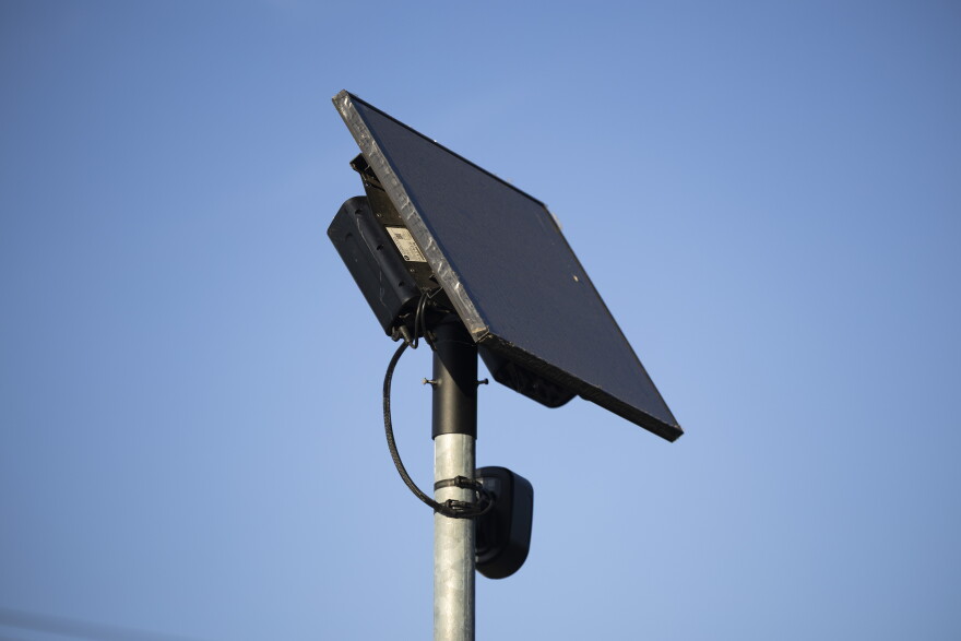 A Flock camera stands in a neighborhood on Koenig in August. The surveillance tech firm has come under fire in recent weeks — and scores of cities, counties and police departments have opted out of using the license plate-reading cameras.