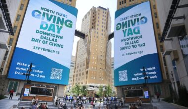 Downtown Dallas Inc. kicked off North Texas Giving Day at the AT&T Discovery District In downtown Dallas, September 15, 2025. The video board is reflected in a plaza sculpture.