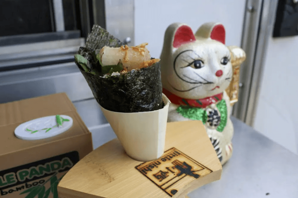 Photo shows a handroll in a stand.
