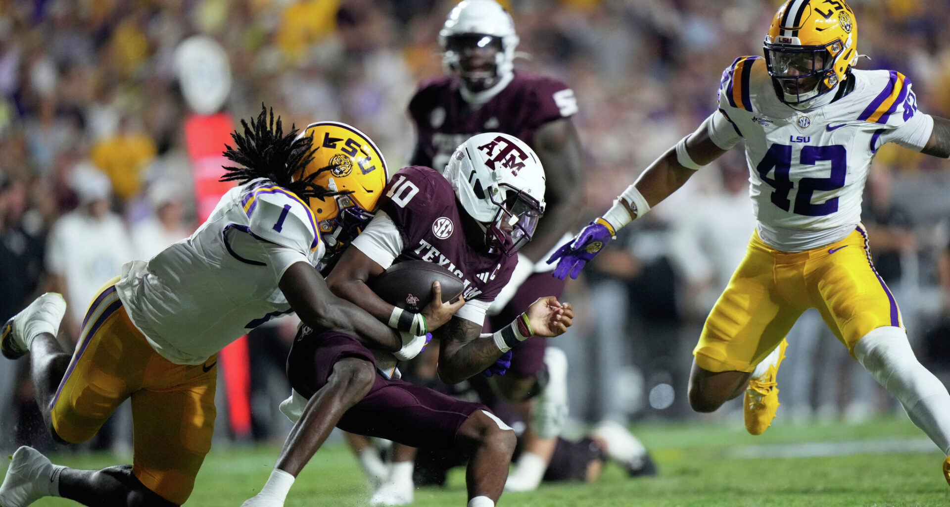 SMU quarterback Kevin Jennings (7), second from right, scores a touchdown as SMU offensive lineman Alex Woods (77) defends against Missouri State linebacker Jared Lloyd (0) during the second half of an NCAA college football game at Gerald J. Ford Stadium in University Park, Saturday, Sept. 26, 2026.
