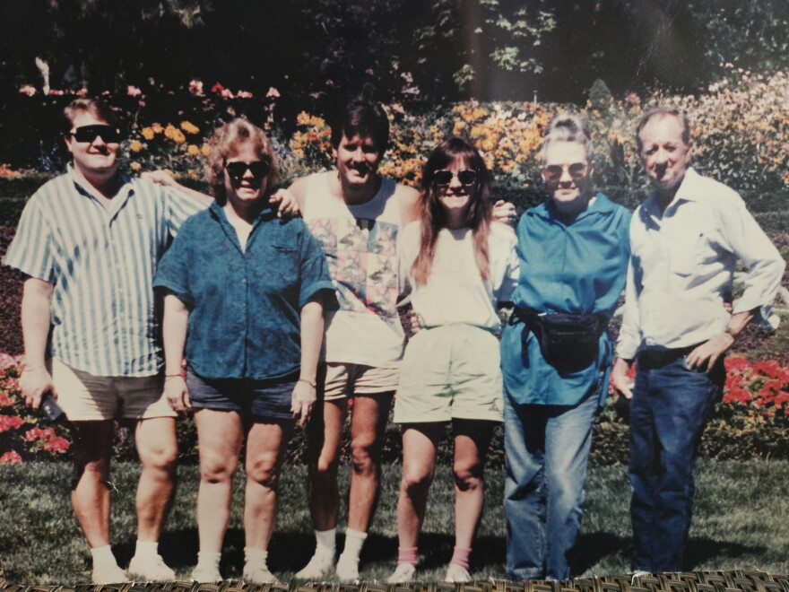 Jay Hodgson and his wife, Barbara, pose for a photo outside with their four children.
