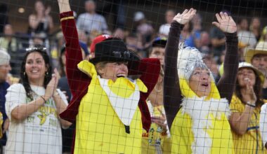 Dressed as characters from The Greatest Showman, Jennifer Hardman, left, and Kat Stevens, right, cheer early in a baseball game between Texas Tailgaters and the Savannah Bananas at Globe Life Field, Sunday Sept. 27, 2026, in Arlington