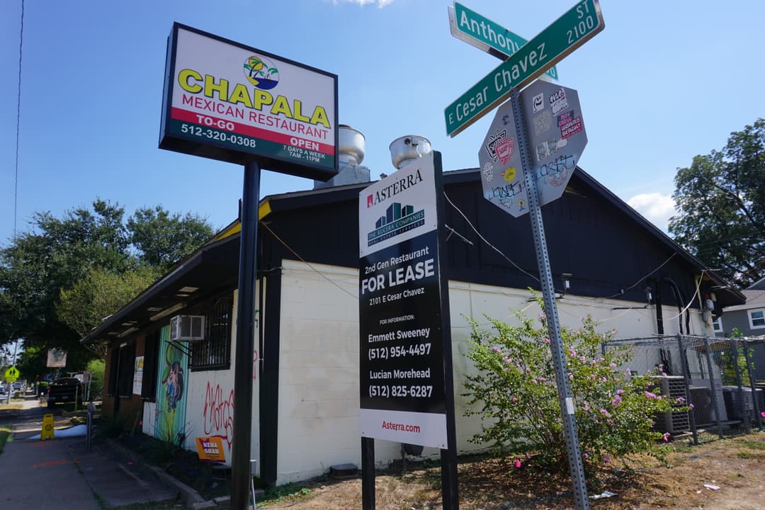 On the corner of East Cesar Chavez and Anthony, a sign sits next to Mexican restaurant Taqueria Chapala stating that it is for lease. Grafiti lines the buildings, melted ice sits out front, and the building is closed.