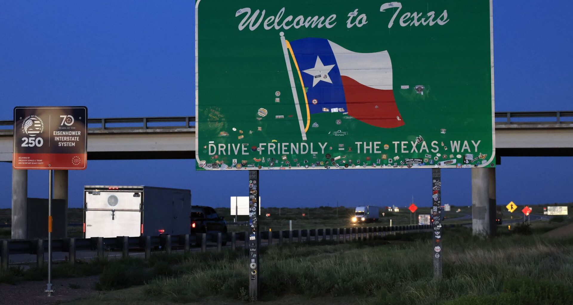 Trucks pass the ‘Welcome to Texas’ highway sign on eastbound Interstate 40 at the New Mexico state border, July 21, 2026.