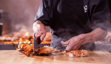 An El Pollo Loco grill master is seen chopping pieces of fire-grilled chicken.